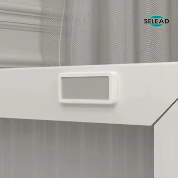 Rectangular cable management port on back of white steel TV console