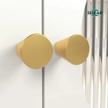 Round gold metal knobs on white fluted glass TV cabinet doors
